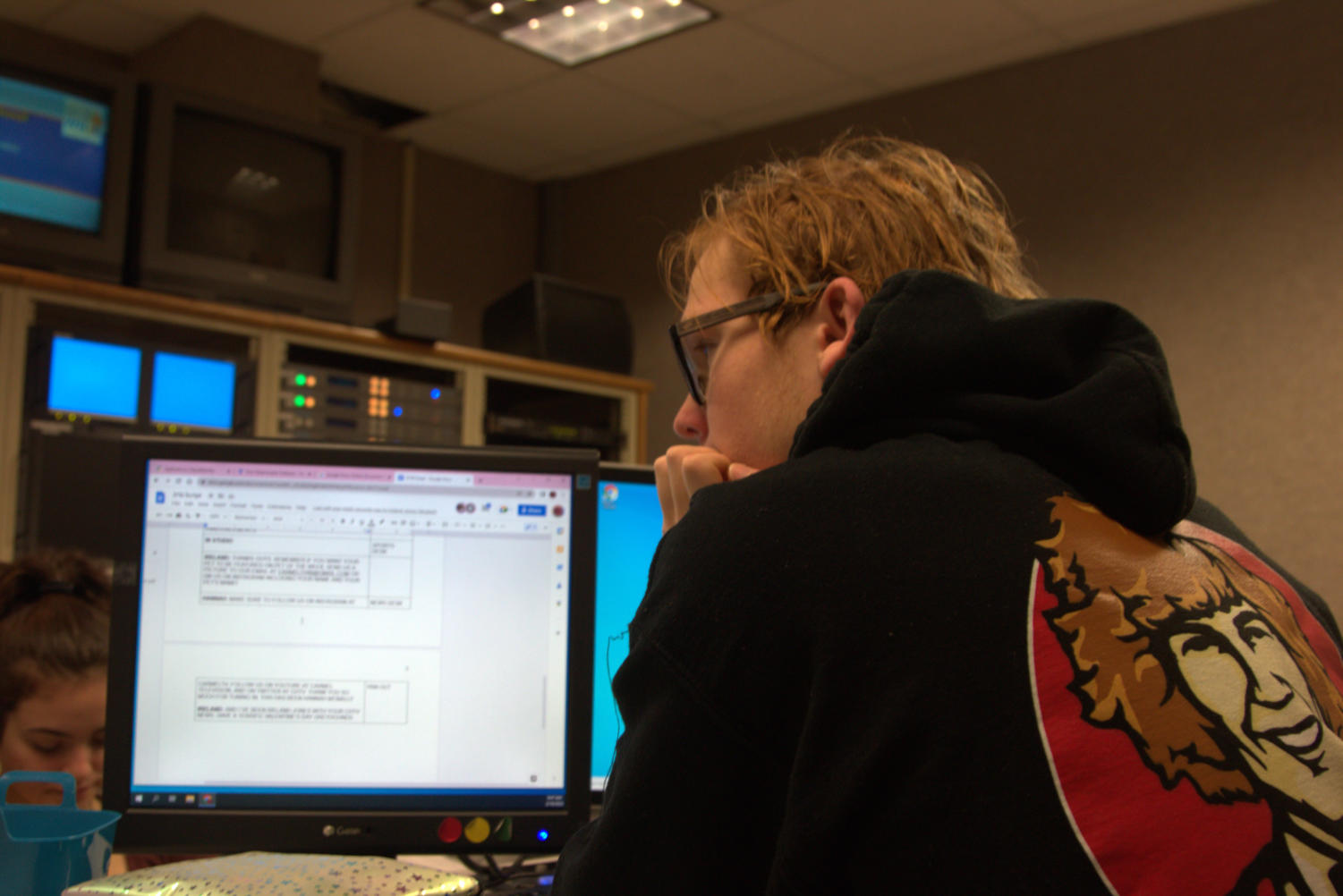 Ryan C. putting the script for the newscast into the teleprompter