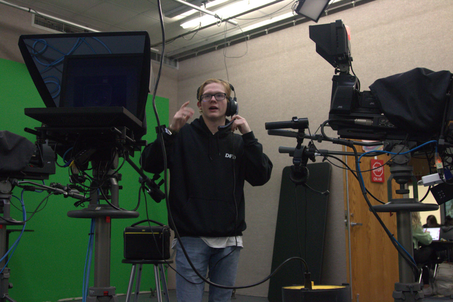 Ryan C. talking to the anchors after getting instructions from the newscast director