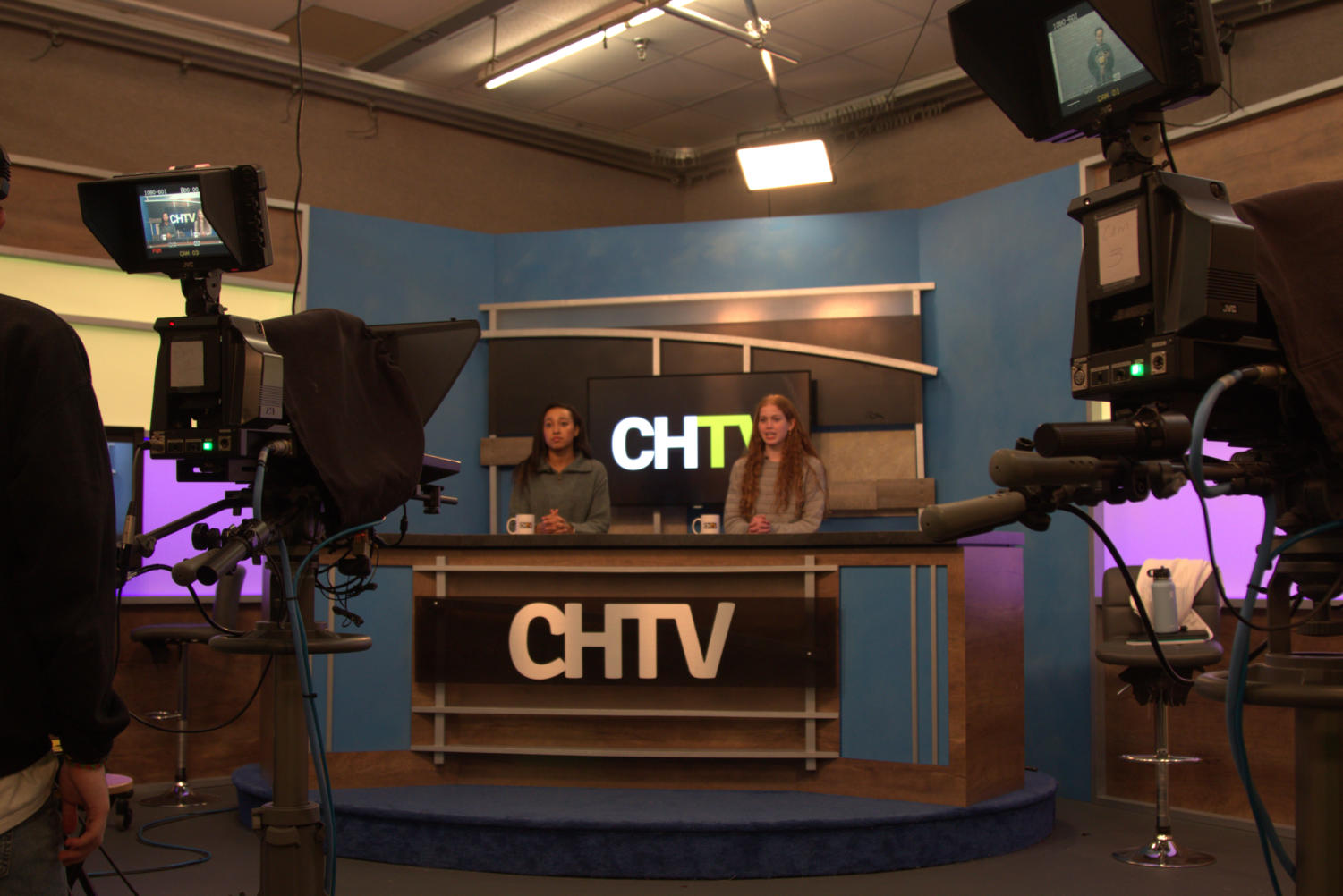 Ireland and Hannah sitting at the CHTV news desk