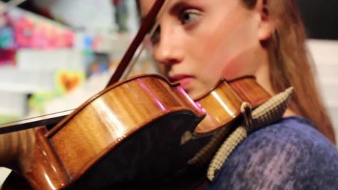A close up shot of Sydney Hartwick playing the violin