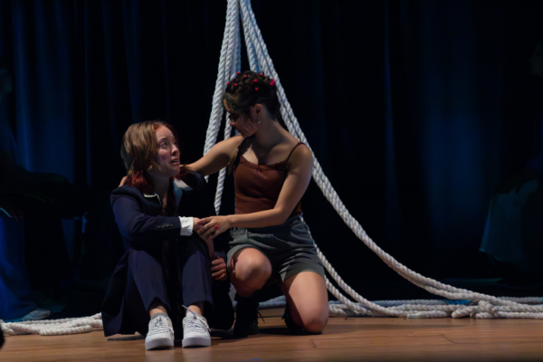 Two students performing a theater production on a stage