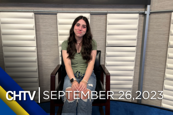 Coral sitting at the entertainment set with the text, CHTV: September 26, 2023 in front of her