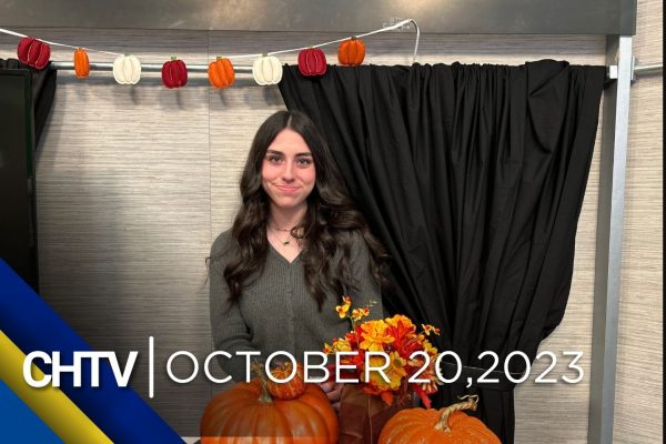 Coral standing at the entertainment set, with the text CHTV: October 20, 2023 in front of her