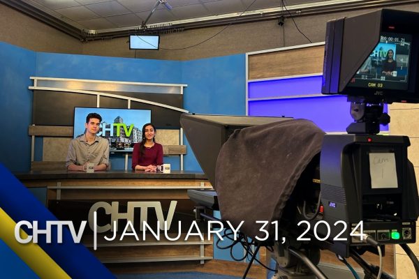A behind the scenes shot of the CHTV studio. Cole and Aarini sitting at the news desk with the text, CHTV: January 31, 2024 in front of them