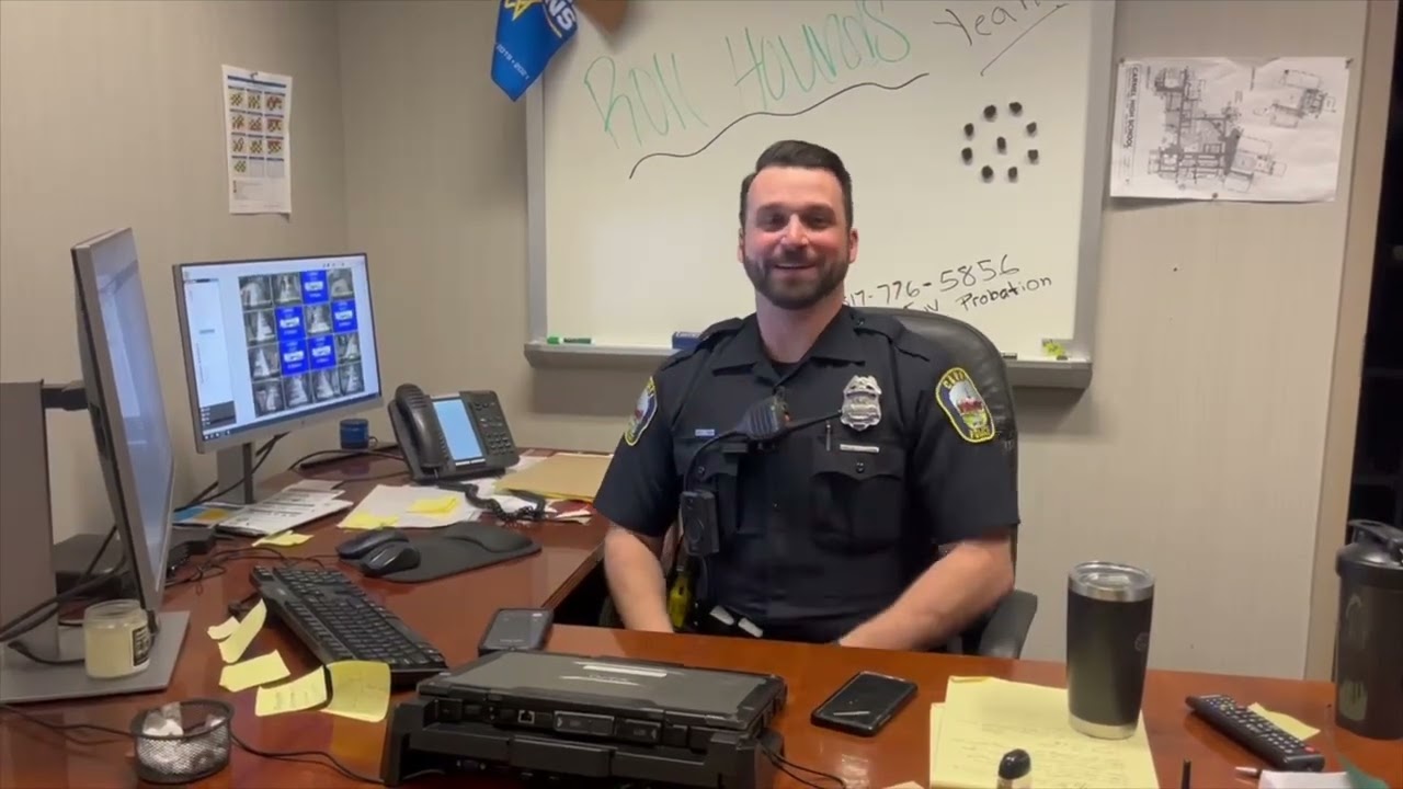 Officer Rogowski sitting at his desk