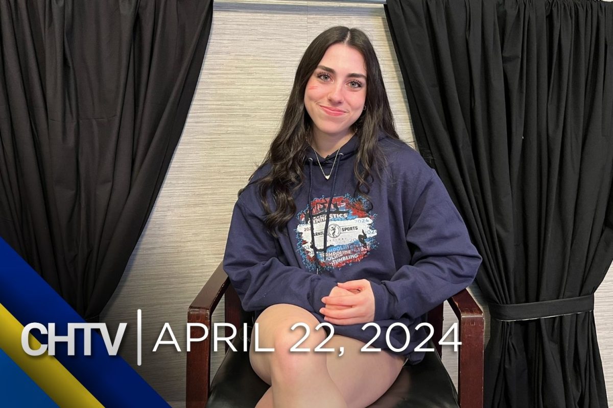 Coral sitting at the entertainment set with the text, CHTV: April 22, 2024 in front of her