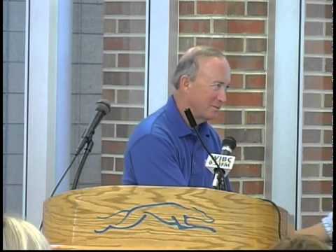 Governor Daniels speaking behind a podium at Carmel High School