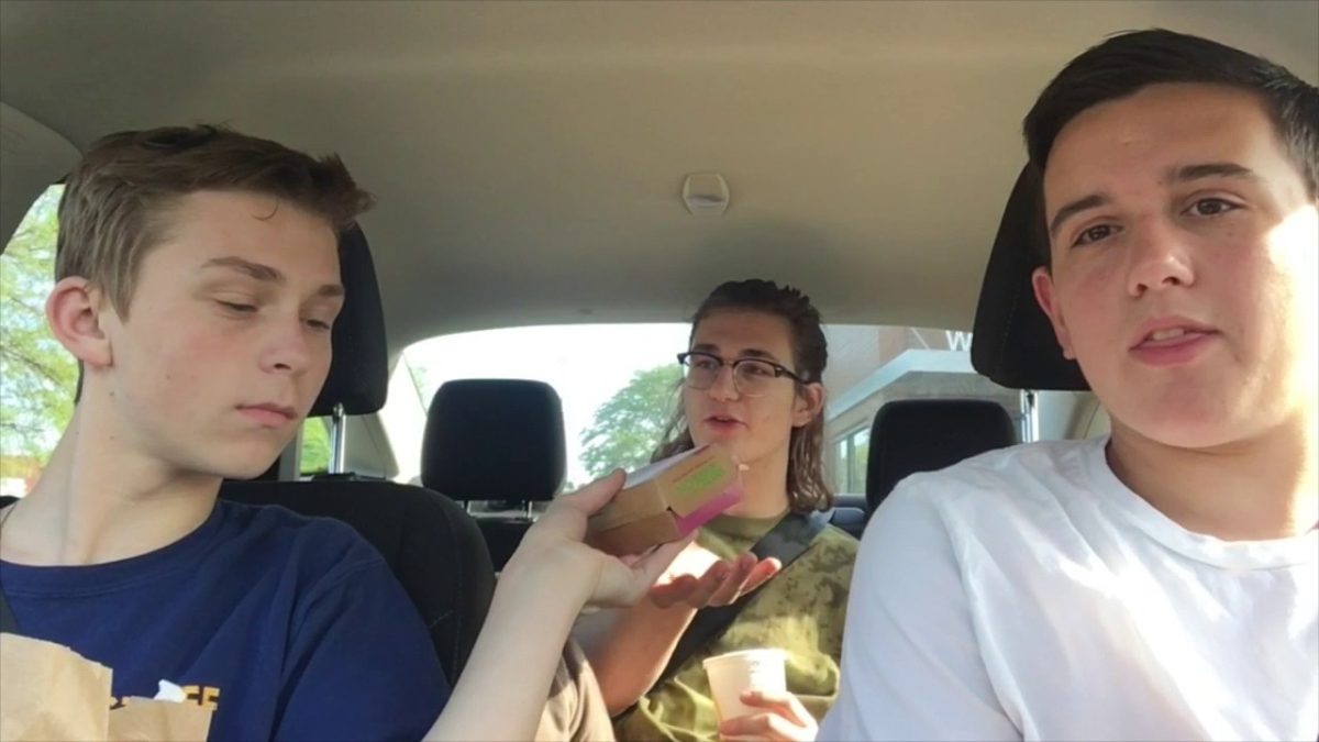 Three high schools students eating McDonald's in a car