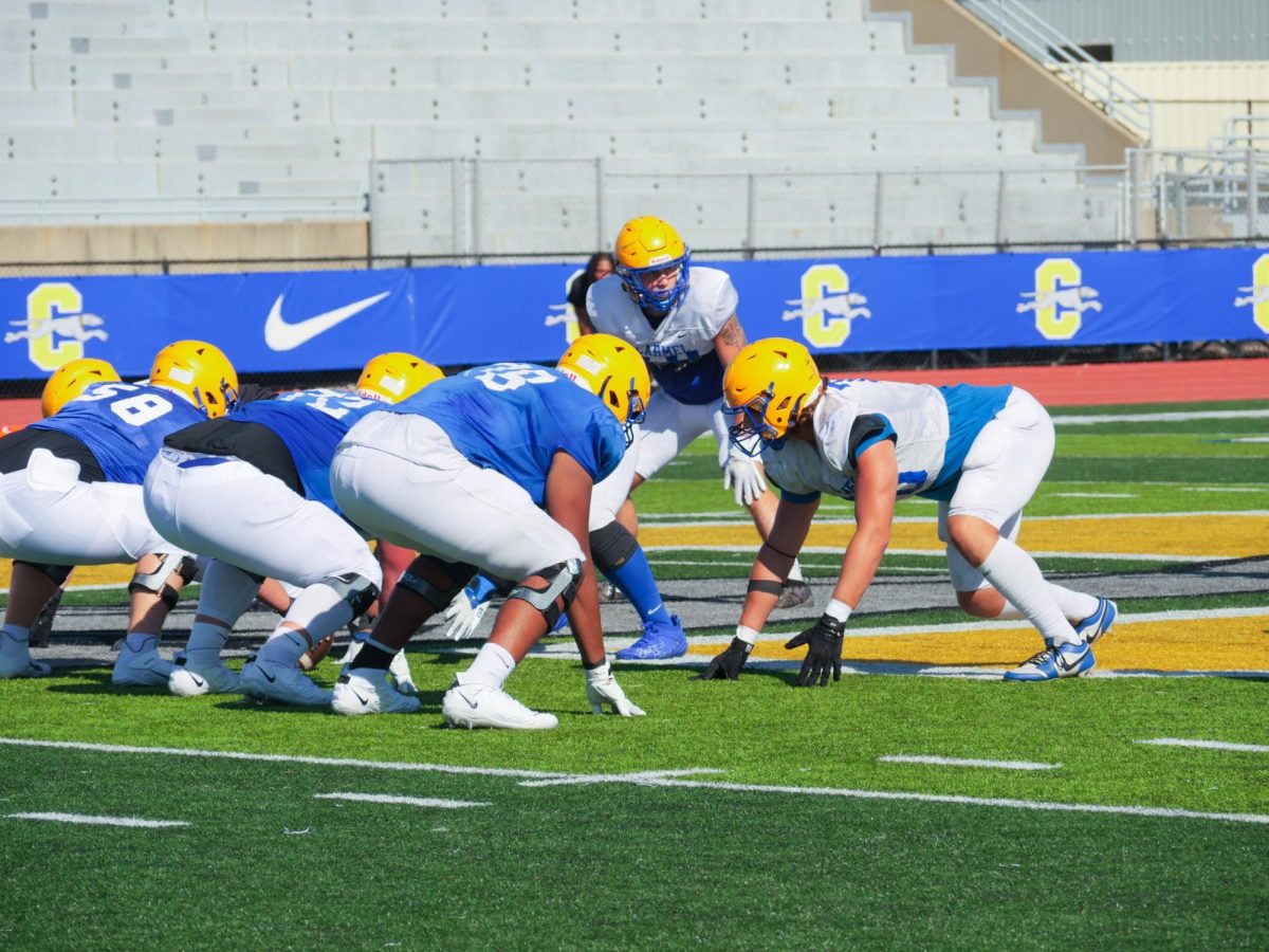 Carmel High School football players on the field about to start a play