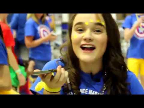 A high school girl holding a phone dressed up for CHS Dance Marathon