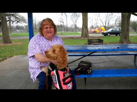 Willow and her service dog sitting at a picnic table