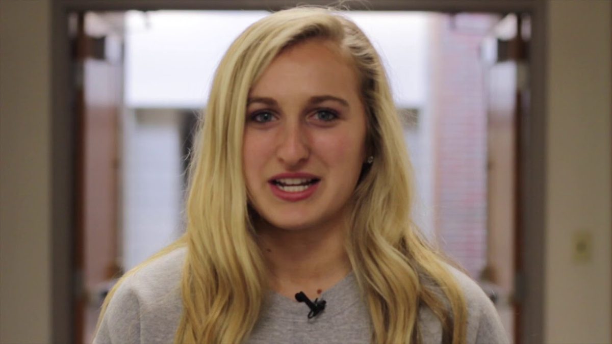 A high school girl standing in a hallway