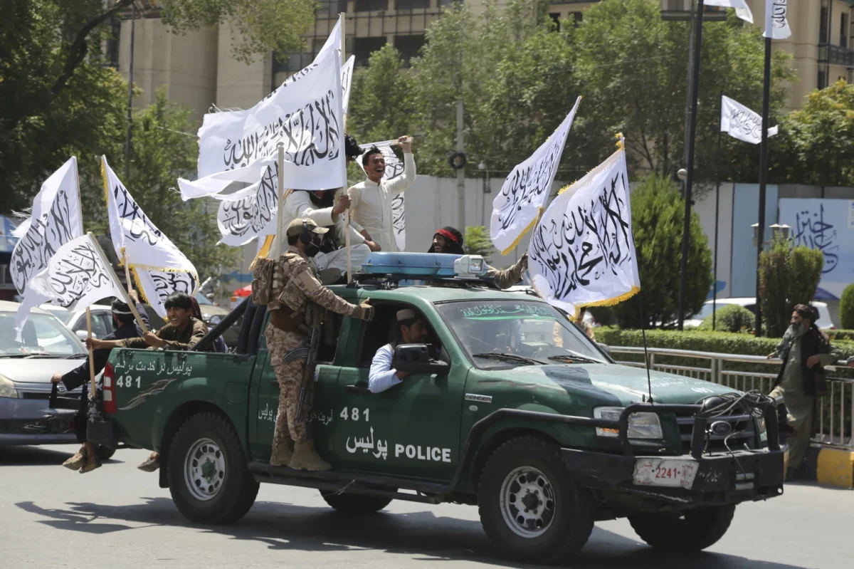 Taliban Truck with leaders and military officials, flying white flags.